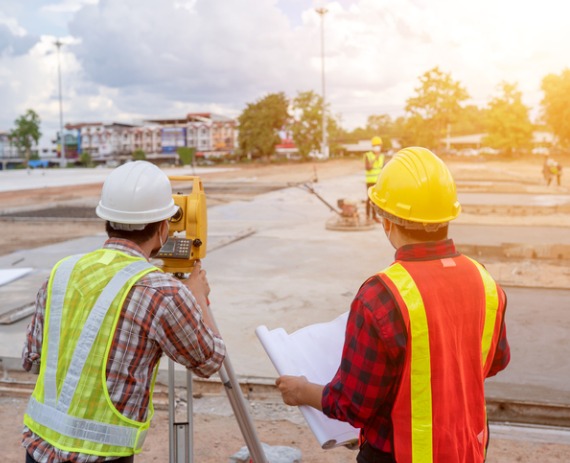 Property Surveyor in Peoria IL inspecting a piece of property at the beginning of construction