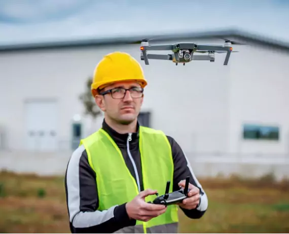 Drone operator flying a photographing drone. Austin Engineering performs drone surveys in Moline IL