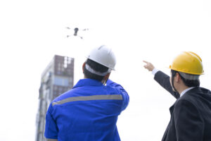Engineer is working on the roof of building doing Drone and Aerial Surveys